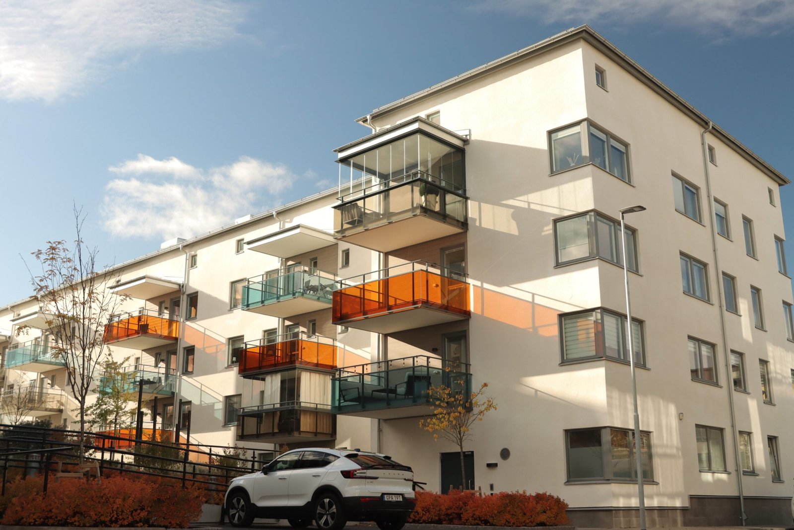 Home A modern apartment building in Jönköping, Sweden with stylish balconies and autumn foliage.